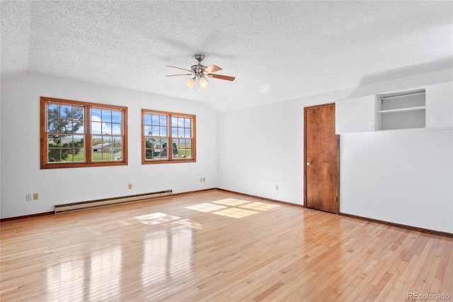 6231 Prospect Rd, Longmont, CO 80503 - unfurnished room with baseboard heating, ceiling fan, a textured ceiling, light wood finished floors, and baseboards