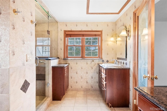 6231 Prospect Rd, Longmont, CO 80503 - full bath with wallpapered walls, a shower stall, vanity, and tile patterned floors
