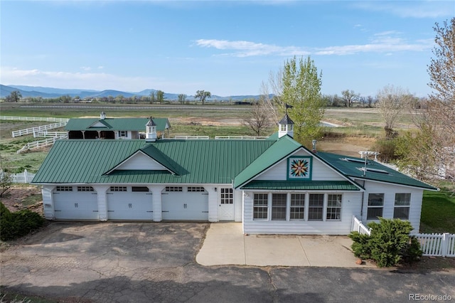 6231 Prospect Rd, Longmont, CO 80503 - view of property with fence, a garage, a mountain view, a view of countryside, and driveway