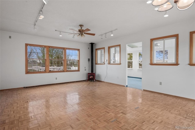 6231 Prospect Rd, Longmont, CO 80503 - spare room with rail lighting, plenty of natural light, baseboards, and a ceiling fan