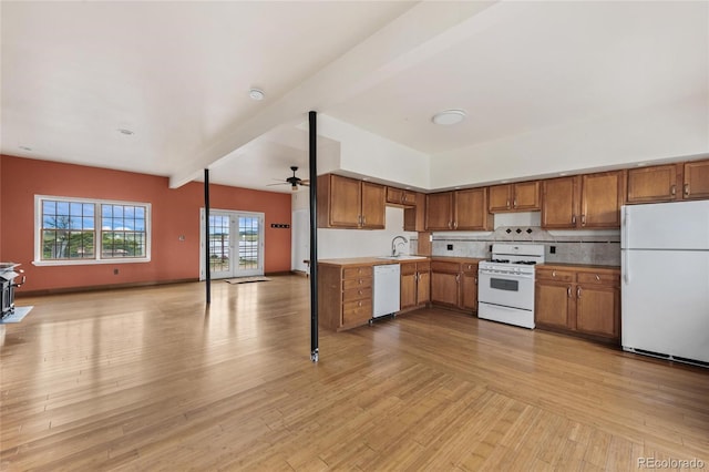 6231 Prospect Rd, Longmont, CO 80503 - kitchen with white appliances, open floor plan, a sink, a ceiling fan, and brown cabinets