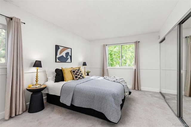 8335 Fairmount Dr Unit 208, Denver, CO 80247 - bedroom featuring light colored carpet and a closet