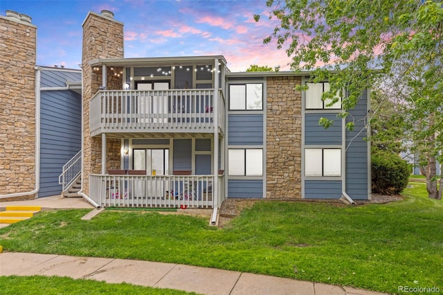 8335 Fairmount Dr Unit 208, Denver, CO 80247 - view of front of home with a front yard and stone siding