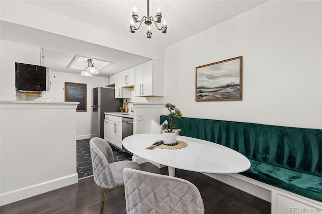 8335 Fairmount Dr Unit 208, Denver, CO 80247 - dining space with dark wood-style flooring and a chandelier