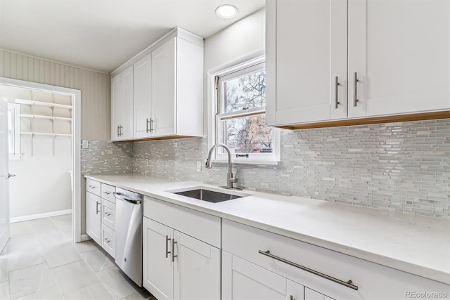 kitchen featuring light countertops, a sink, and dishwasher