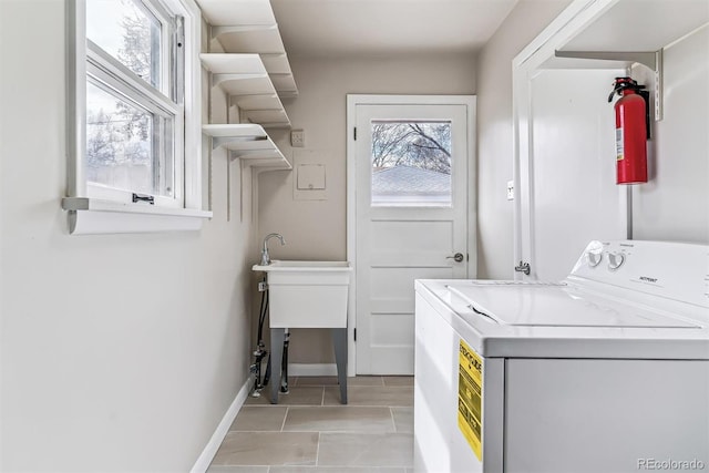 clothes washing area featuring washer / clothes dryer, baseboards, and laundry area