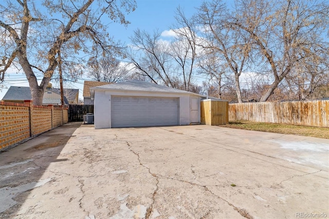 detached garage featuring fence