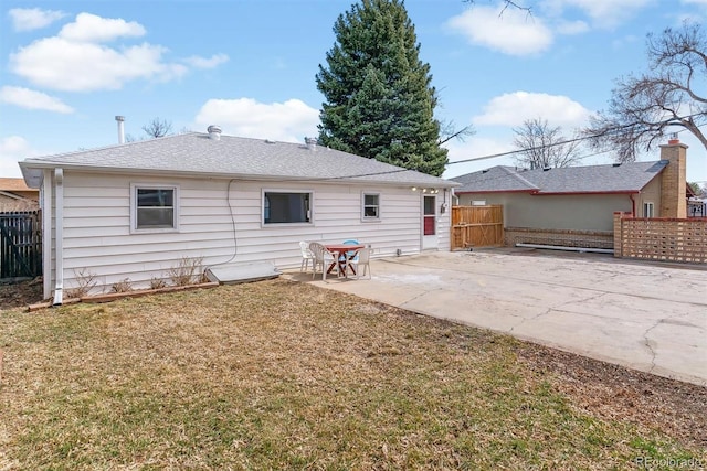 back of property with a patio area, fence, and a lawn