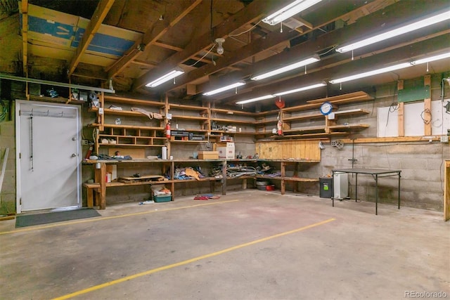 garage with a workshop area and concrete block wall