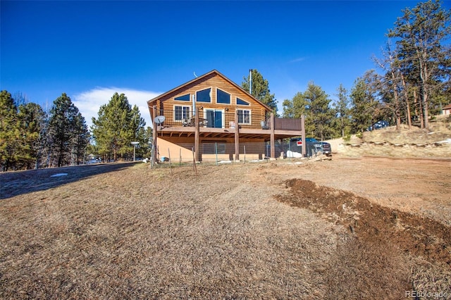 rear view of property with a wooden deck