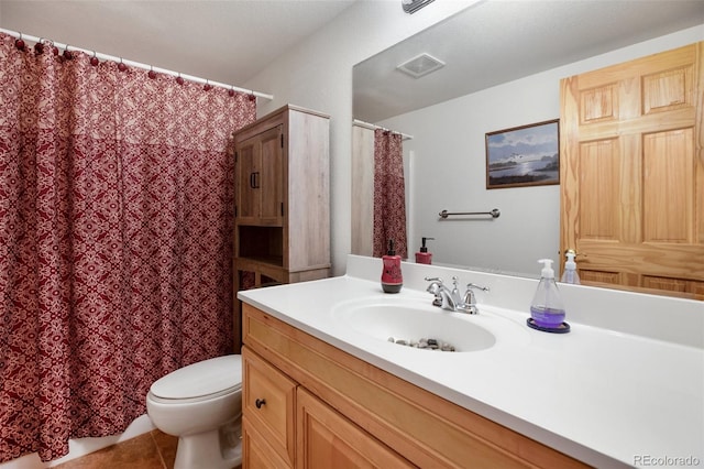 bathroom with tile patterned flooring, vanity, and toilet