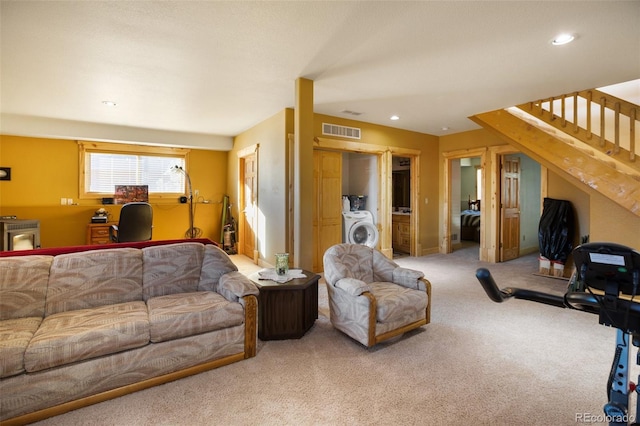 carpeted living room featuring washer / clothes dryer