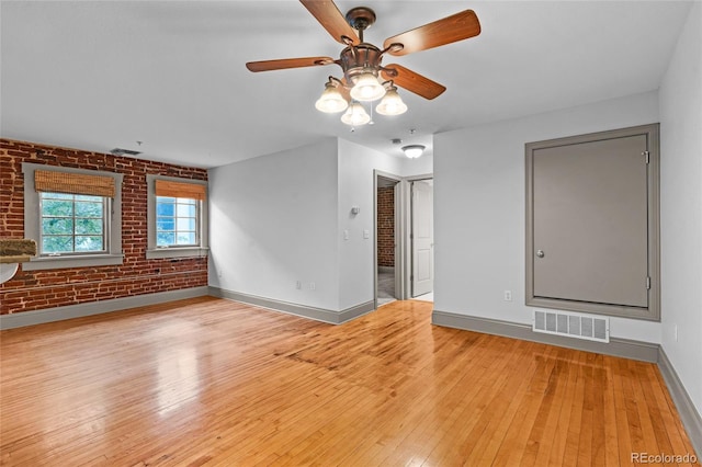 3211 Zuni St Unit 14, Denver, CO 80211 - unfurnished room featuring light wood-style floors, baseboards, brick wall, and ceiling fan