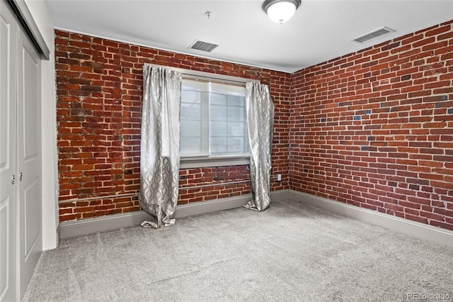 3211 Zuni St Unit 14, Denver, CO 80211 - carpeted empty room with baseboards, brick wall, and a pendent fire sprinkler