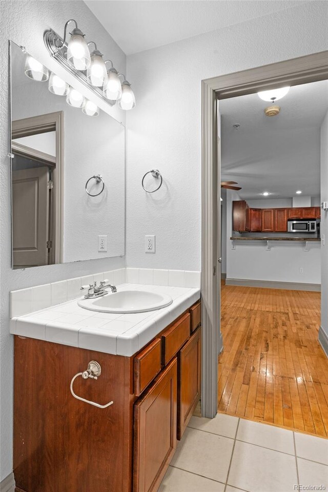 3211 Zuni St Unit 14, Denver, CO 80211 - bathroom with vanity, baseboards, and tile patterned floors