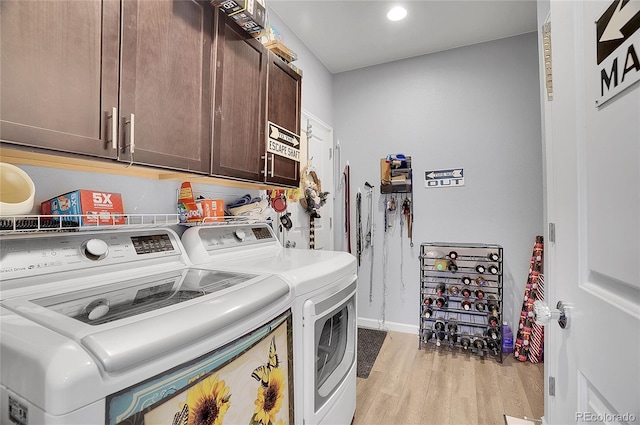 laundry area with recessed lighting, baseboards, washing machine and clothes dryer, light wood-type flooring, and cabinet space