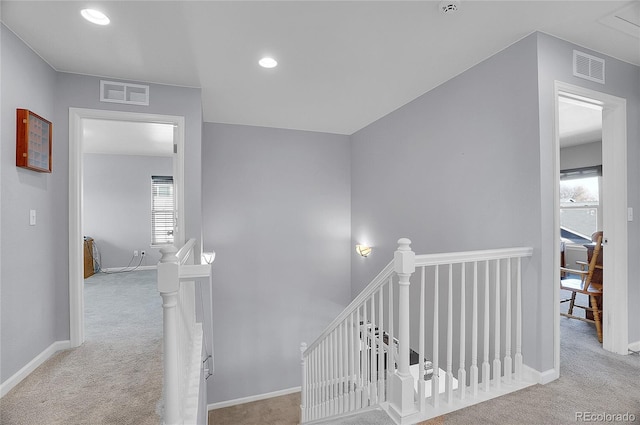 stairs with visible vents, carpet flooring, baseboards, and recessed lighting