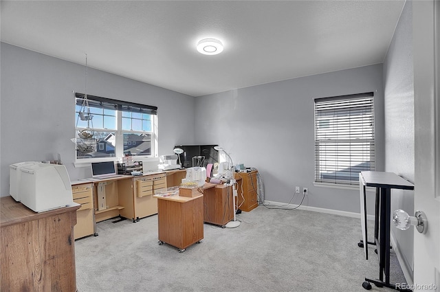 office area with baseboards and light carpet