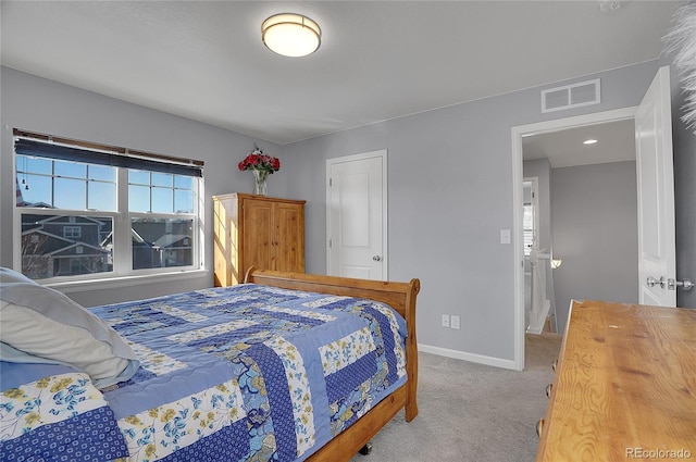 carpeted bedroom featuring baseboards, visible vents, and multiple windows