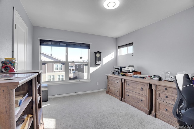 carpeted office space featuring baseboards