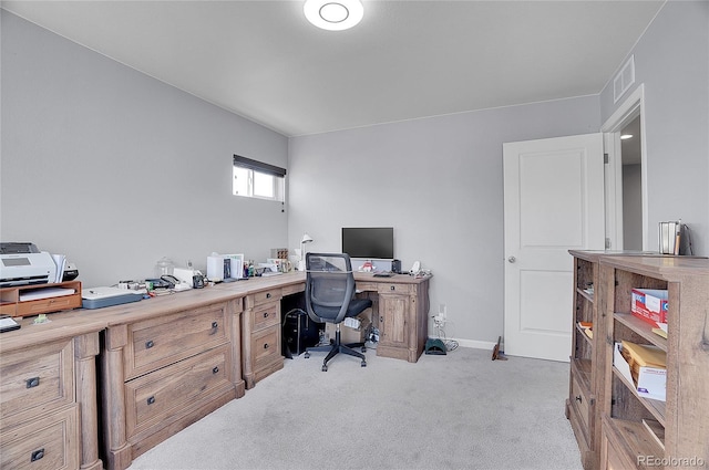 carpeted office featuring visible vents and baseboards