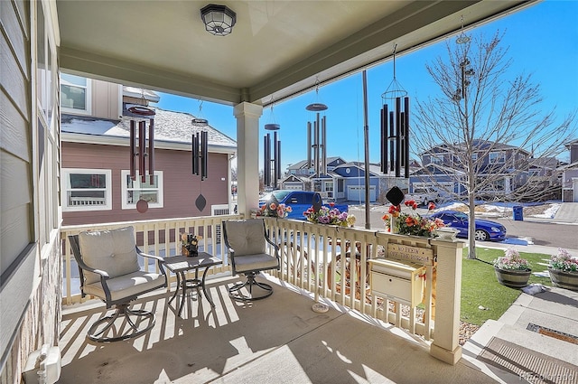 view of patio featuring a porch and a residential view