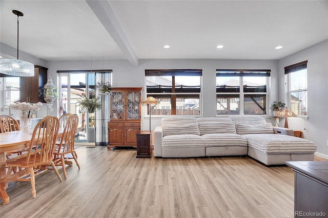 living room with beamed ceiling, recessed lighting, and light wood-type flooring