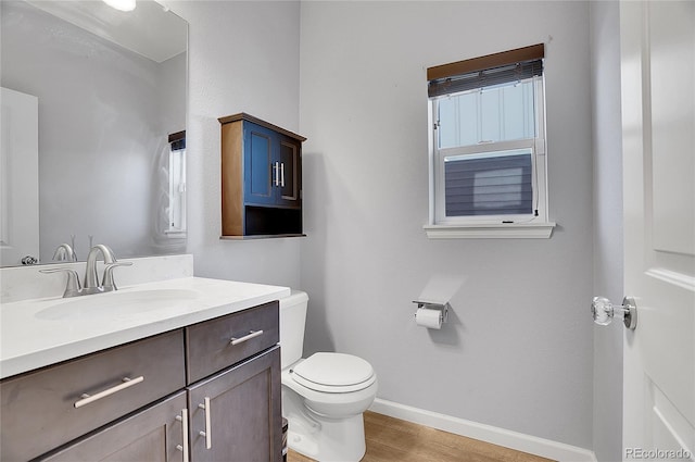 7888 Tejon St, Denver, CO 80221 - bathroom with wood finished floors, baseboards, toilet, and vanity