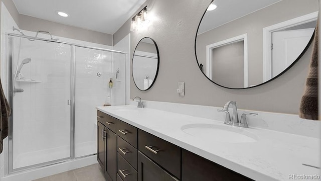 7888 Tejon St, Denver, CO 80221 - bathroom featuring a shower stall, double vanity, tile patterned flooring, and recessed lighting
