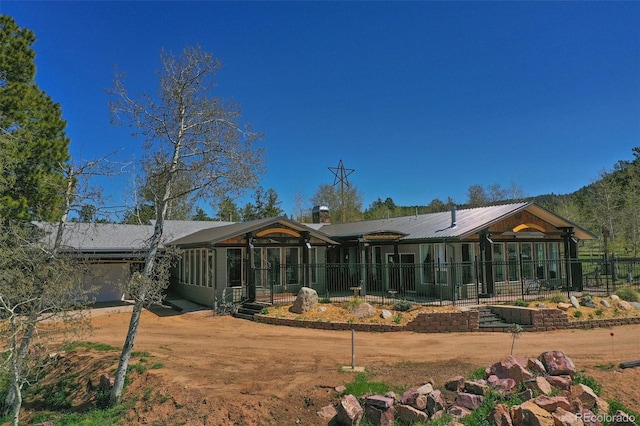 rear view of property with a garage