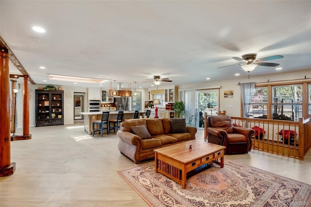 living room featuring ceiling fan and light hardwood / wood-style floors