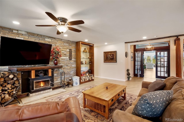 living room with ceiling fan, a fireplace, french doors, and light wood-type flooring