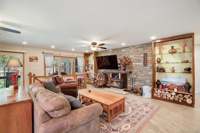 living room featuring light hardwood / wood-style floors and ceiling fan