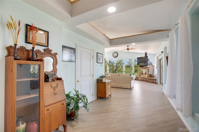 hall featuring light hardwood / wood-style floors and vaulted ceiling