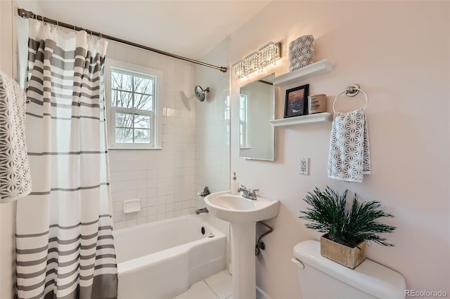 bathroom with tile patterned floors, toilet, and shower / tub combo