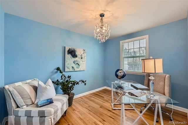 office with hardwood / wood-style flooring and a chandelier