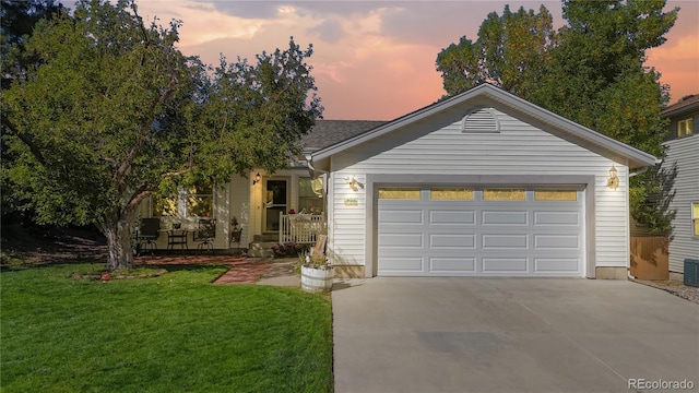 view of front facade with a garage and a yard