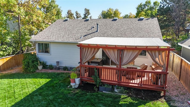 back of house featuring a yard and a deck