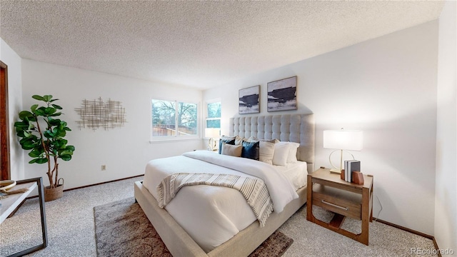 carpeted bedroom featuring a textured ceiling