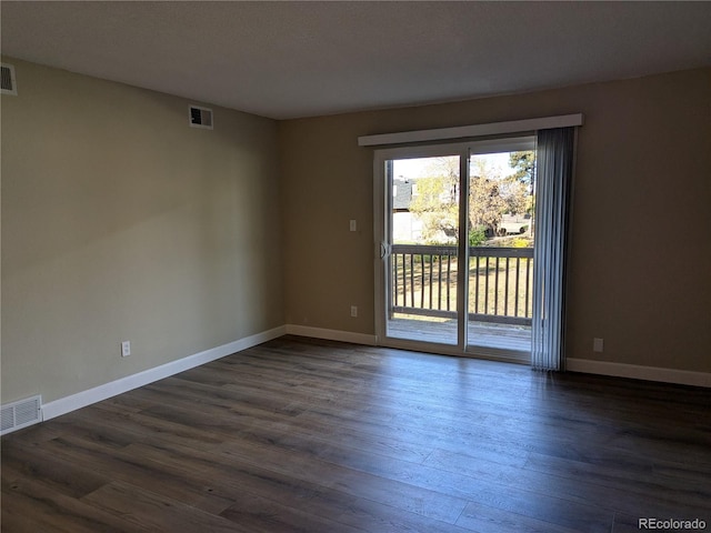 empty room featuring dark hardwood / wood-style flooring