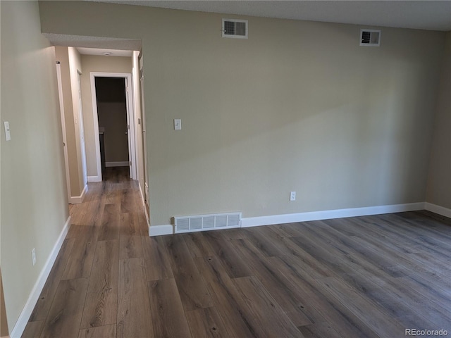 unfurnished room with dark hardwood / wood-style flooring