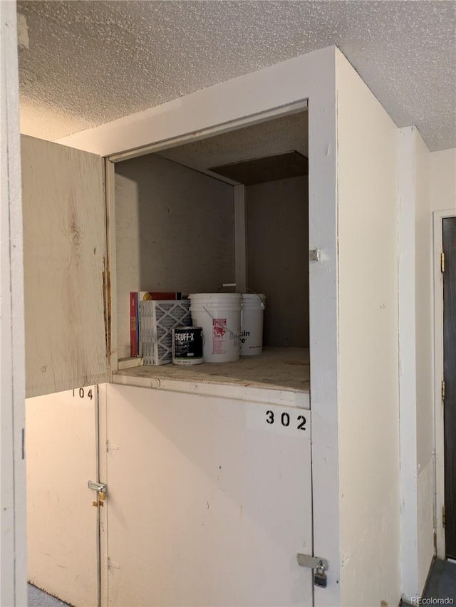 laundry area featuring a textured ceiling