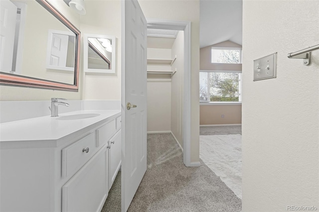 3565 W 112th Cir, Westminster, CO 80031 - bathroom with vaulted ceiling, vanity, and baseboards