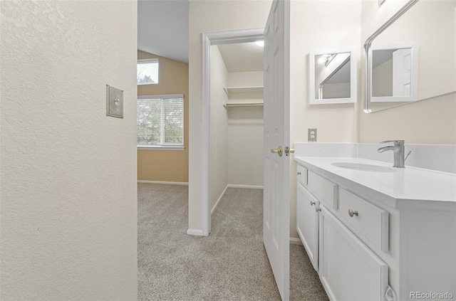 3565 W 112th Cir, Westminster, CO 80031 - bathroom with vanity, baseboards, and a textured wall