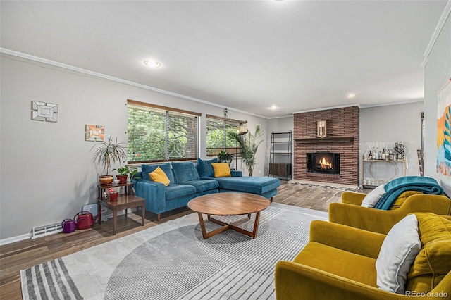 120 Field St, Lakewood, CO 80226 - living area with ornamental molding, wood finished floors, baseboards, recessed lighting, and a brick fireplace