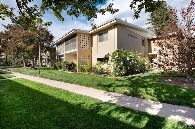 view of property exterior with a yard and stucco siding