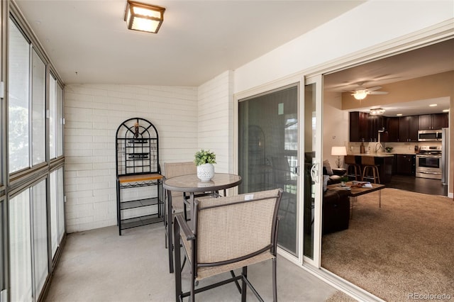 sunroom with a sink and ceiling fan