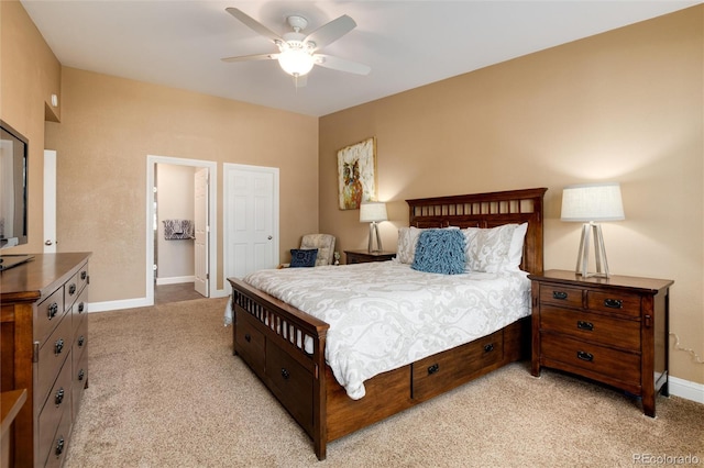 bedroom featuring light colored carpet, a ceiling fan, and baseboards