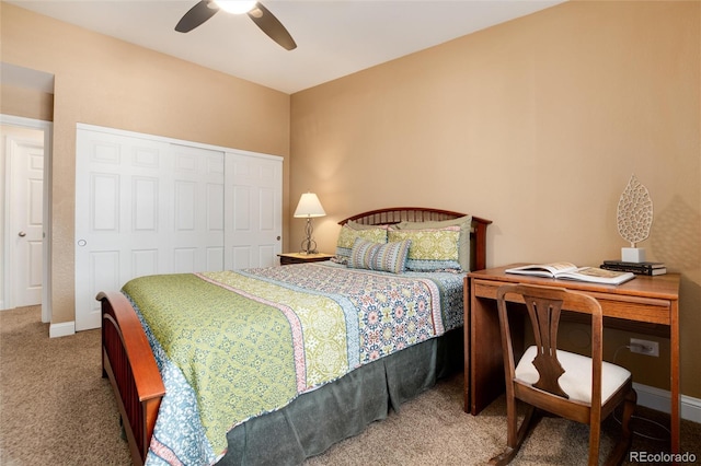 carpeted bedroom featuring a closet, baseboards, and ceiling fan