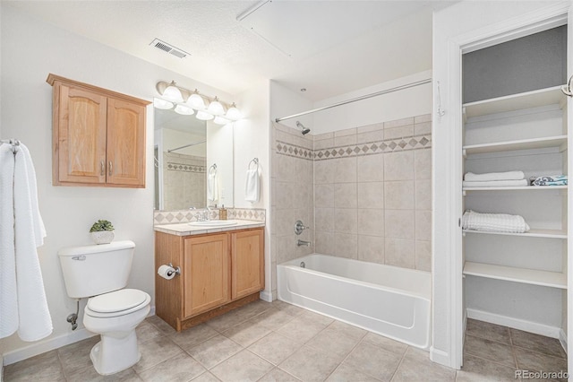10149 W 55th Dr Unit 3, Arvada, CO 80002 - bathroom with vanity, washtub / shower combination, tile patterned flooring, and toilet